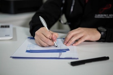 Doctor creating a medical note for a patient’s leave from work.