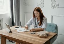 Doctor writing a note in a notebook to support a patient's sick leave needs.